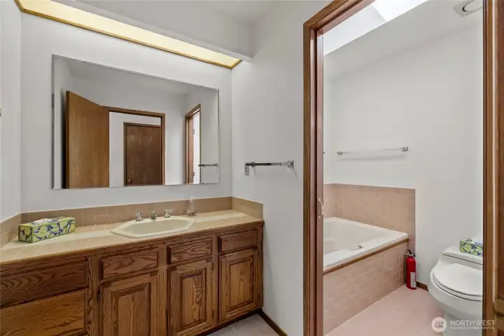 Guest bath offers a jetted tub