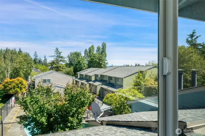 Looking out the primary bedroom with partial a water view.