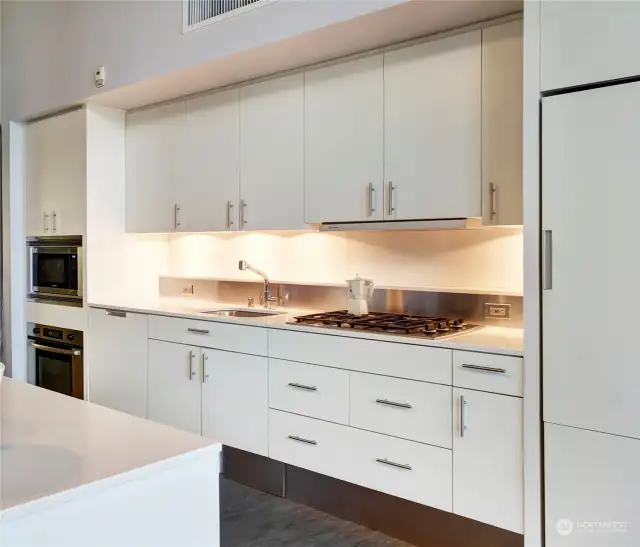 Enjoy a modern and functional kitchen with bar island, quartz counters and gas range.