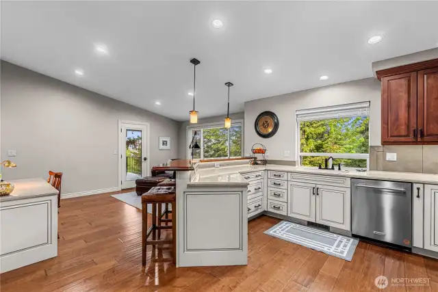 Kitchen to den with an eating bar and office/desk.