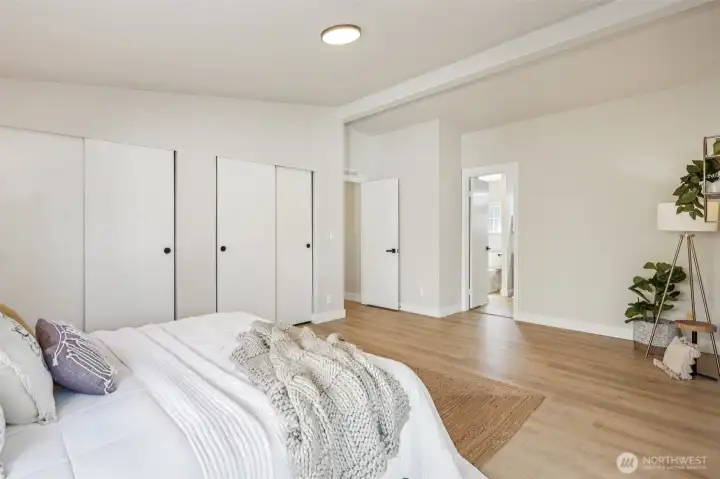 Primary bedroom with ensuite bathroom. Vaulted ceilings, new interior paint and LVP floors, hardware, light fixtures, and trim.