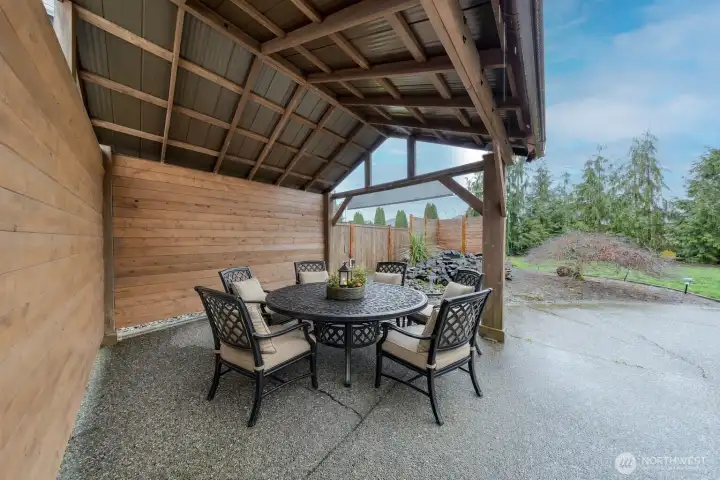 Gazebo overlooking water feature in backyard.  Staged Furniture