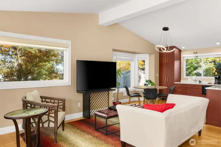 Spacious living room with new Anderson windows, new hardwoods and vaulted ceiling.