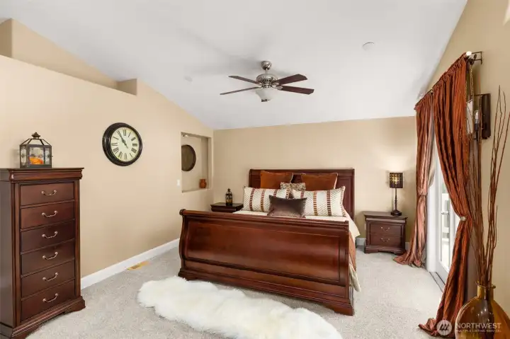 Primary suite with new carpet, walk-in closet, vaulted ceilings and a full ensuite.