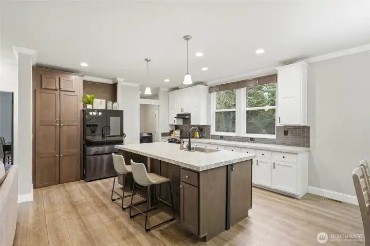 Large center island with bar seating offers the perfect spot for casual meals and conversation.