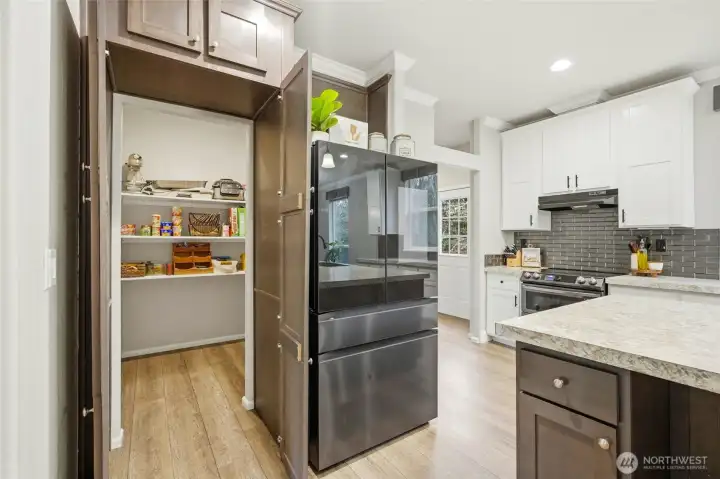 Oversized walk-in pantry hidden in plain sight adds a fun and practical surprise.