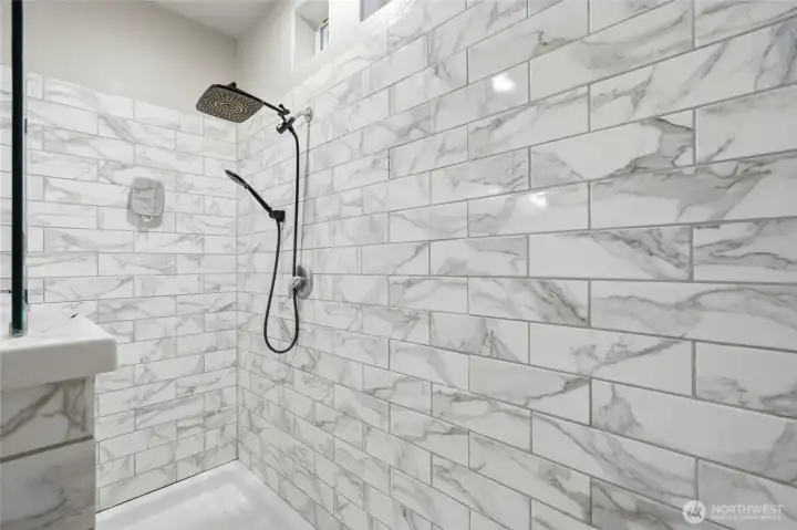 Separate oversized walk-in shower offers a clean, modern feel.
