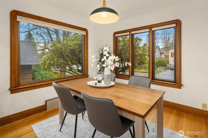Dining room framed by large windows.