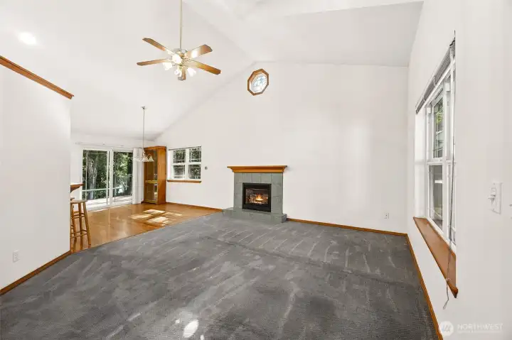 Spacious living and dining area with cathedral ceilings and gas ( propane) fireplace