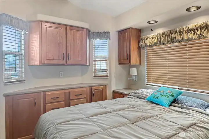 Built-in cabinetry and thoughtful storage maximize space in this comfortable bedroom.