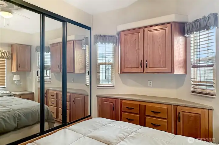 Mirrored closet doors and ample built-ins offer great storage while enhancing the sense of space.