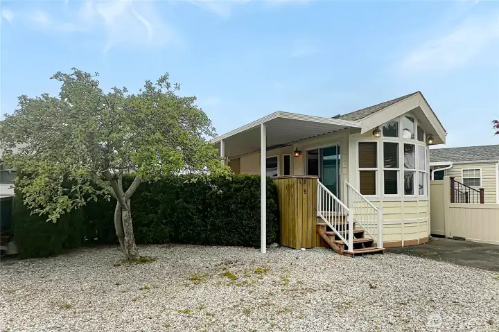 Charming mature landscaping creates a private retreat inside the fenced yard.