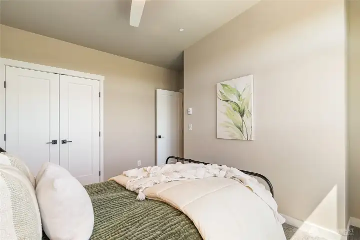 Main bedroom with ceiling fan & French door closet