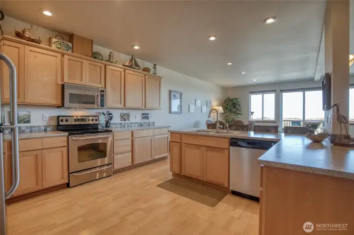 The kitchen is spacious and functional, and features stainless steel appliances.