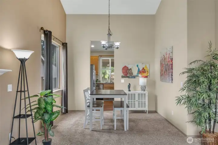 Formal dining area with dramatic vaulted ceilings and oversized windows, providing an abundance of natural light. Conveniently located just off the kitchen, making gatherings and entertaining a breeze.