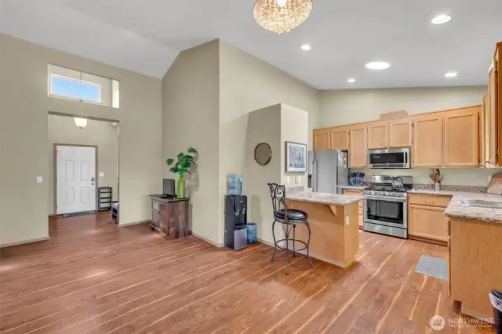 The heart of the home! Spacious family room flows into the well-appointed kitchen with granite countertops, maple cabinetry, stainless steel appliances, and breakfast bar seating, creating an inviting space for everyday living and entertaining.