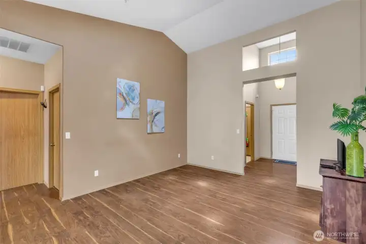 Spacious family room with durable wood-look flooring and recessed lighting.