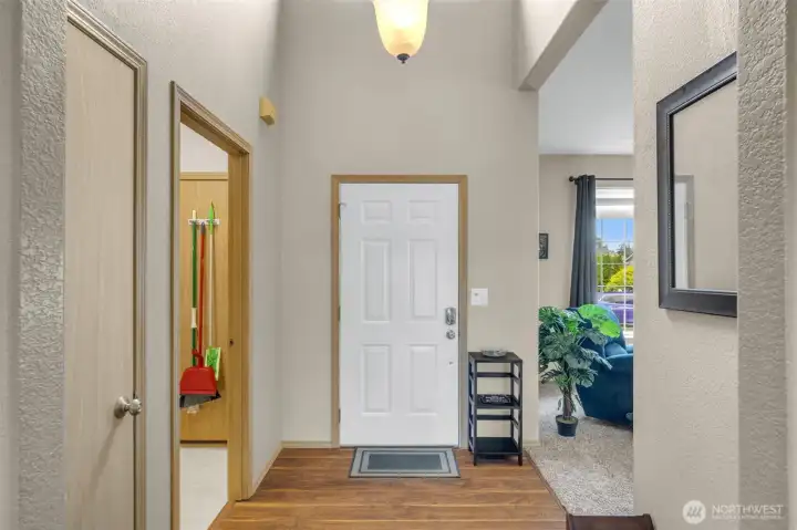 Welcoming foyer with soaring ceilings, durable wood-look flooring, and an inviting entry that opens to the spacious living areas.