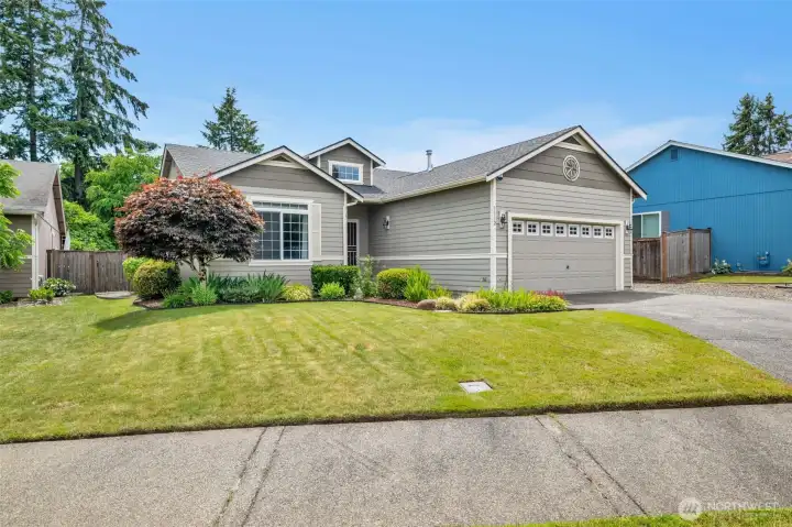 Beautifully maintained rambler featuring attractive landscaping, excellent curb appeal, and a spacious two-car garage in the gated Wildhorse community.