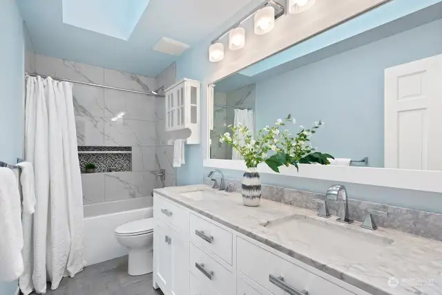 Beautifully remodeled Hall bath with skylights, marble countertop, new cabinetry/tub/tile/shower and lighting