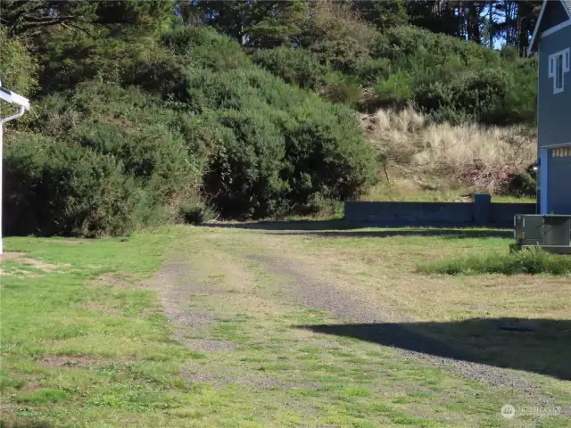 Road is up on the hill past the blue house