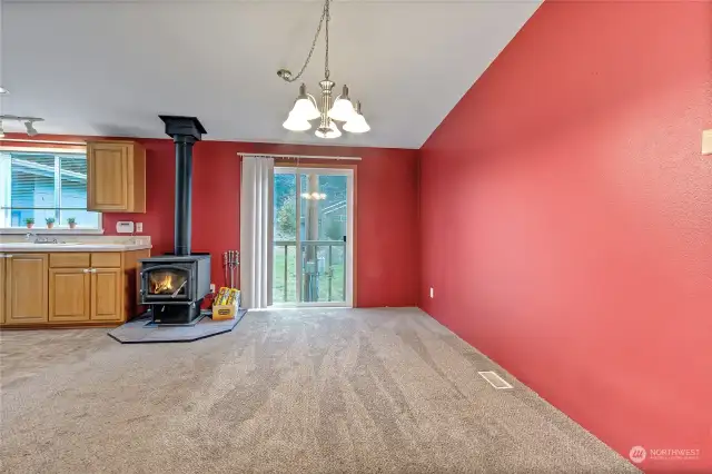 Cozy wood burning stove in formal dining that flows into living room.