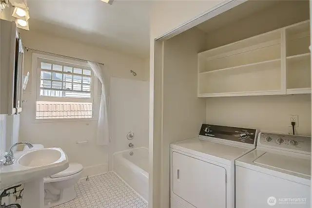 Full bathroom on the second floor, featuring a washer and dryer