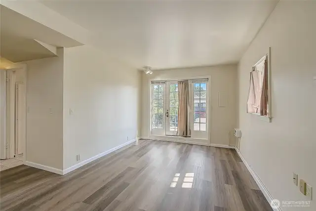 Lower unit living room features new vinyl plank flooring installed in 2019.