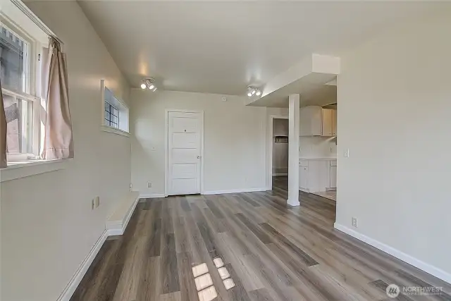 Lower unit living room is adjacent to two bedrooms, the kitchenette, and the second full bathroom