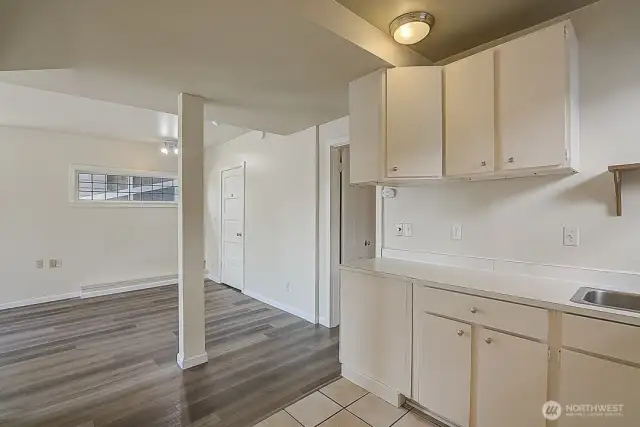 Lower unit kitchenette, living room, and bedroom, showcasing an open layout and convenient access to each space