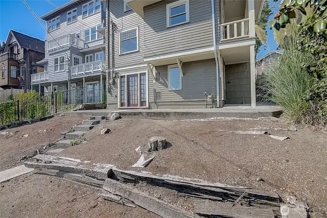 House backside view from 20th Ave NE, showcasing the rear of the property and surrounding area.