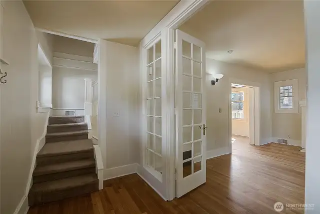 Main entry features a stairway to the second floor, with the living room and dining area to the right.