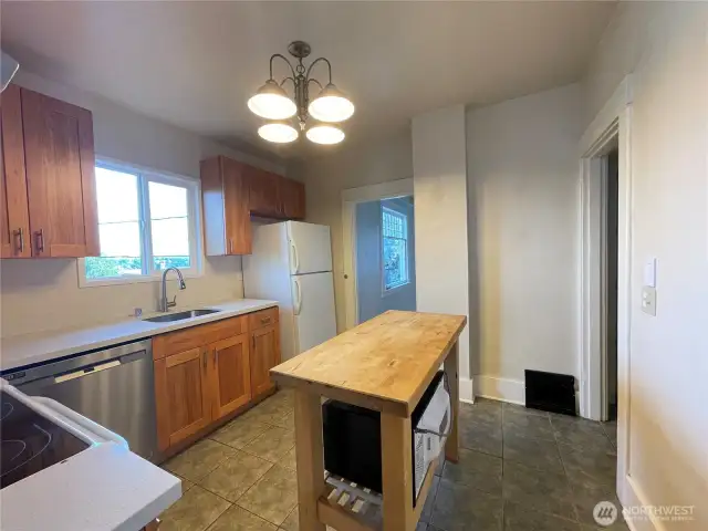 Remodeled kitchen connects to the dining room and provides access to the stairway