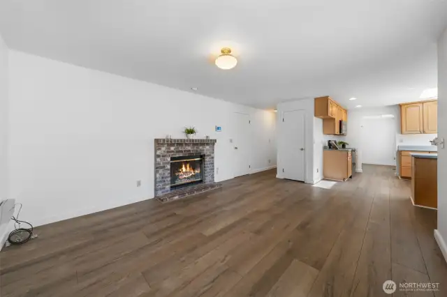 Family room with wood fireplace and door leading out to the level huge fully fenced backyard. Enjoy many nights cuddling up to the fireplace.