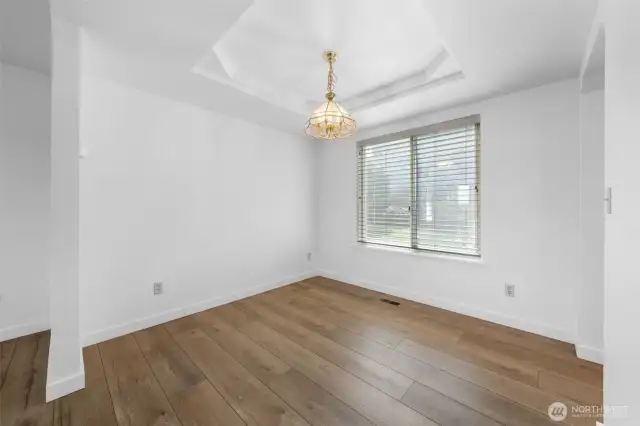 Formal dining room with coffered ceiling.
