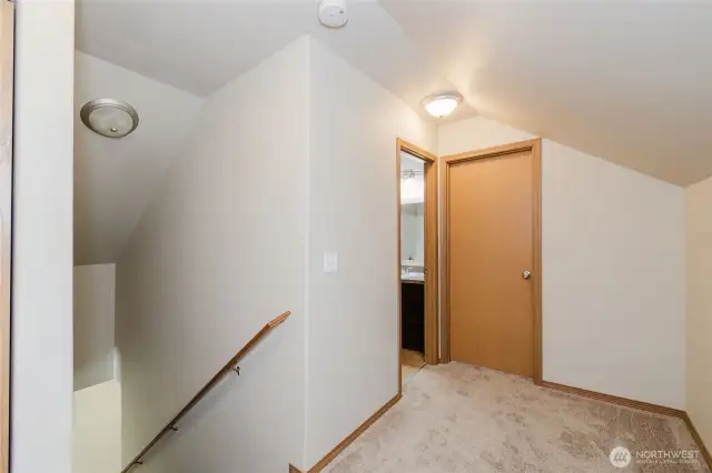 Stairs going to the two large bedrooms and full bath on the top floors.