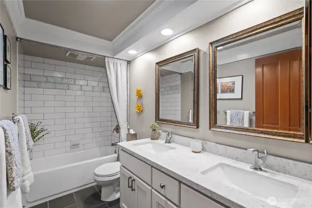 An updated full bathroom, conveniently located in the hallway between the bedrooms and kitchen, offers easy access for everyone.