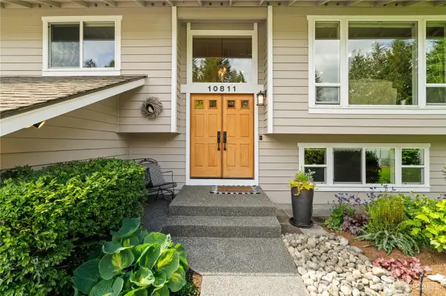 As you approach the front door, you'll be greeted by lush, mature landscaping that enhances the home's beauty and provides timeless curb appeal.