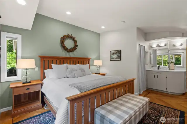 The spacious primary ensuite bedroom features a walk-in closet and a recently updated bathroom.