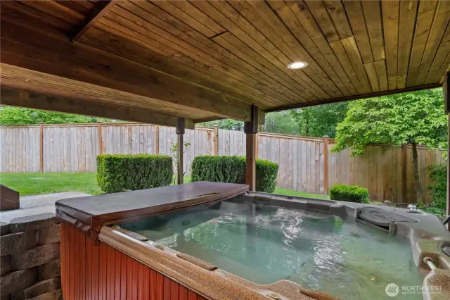 The hot tub is nestled in a beautifully manicured, private backyard that backs onto a peaceful greenbelt—providing the perfect view as you soak away the worries of the day.