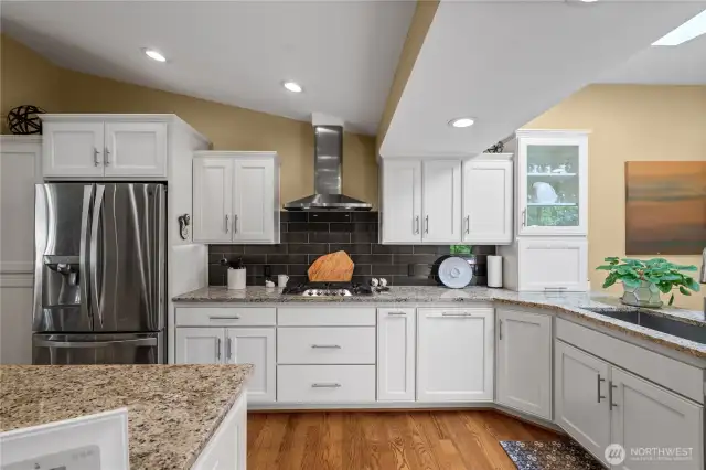 The fully permitted kitchen remodel showcases classic shaker-style cabinetry, sleek slab granite countertops, and stylish subway tile accents. Just off the kitchen, a cozy family room offers seamless access to a spacious outdoor balcony—perfect for relaxing or entertaining.