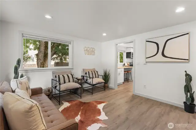 spacious living room with plenty of wall space for mounted tv, cute dining tablem sectional couch?