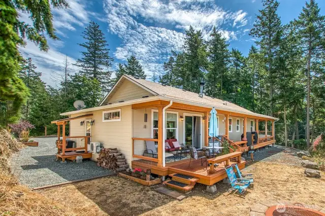 Covered porch runs the full length of the west side of the house for enjoyable outdoor living.