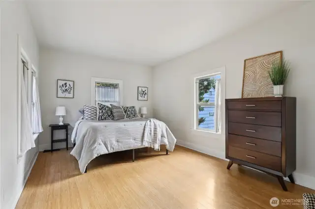 Primary bedroom has bamboo flooring windows on all three walls, so is absolutely drenched in natural light