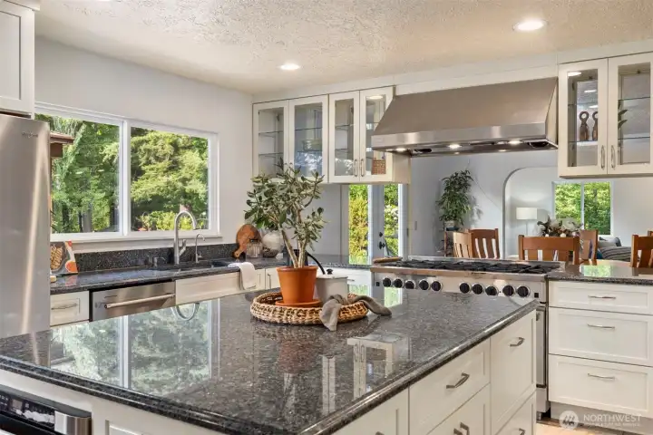 A large island with a built-in microwave and plenty of space to gather and curate your meals