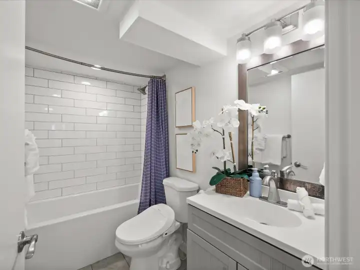 Lower level full bathroom with deep tub and shower head.