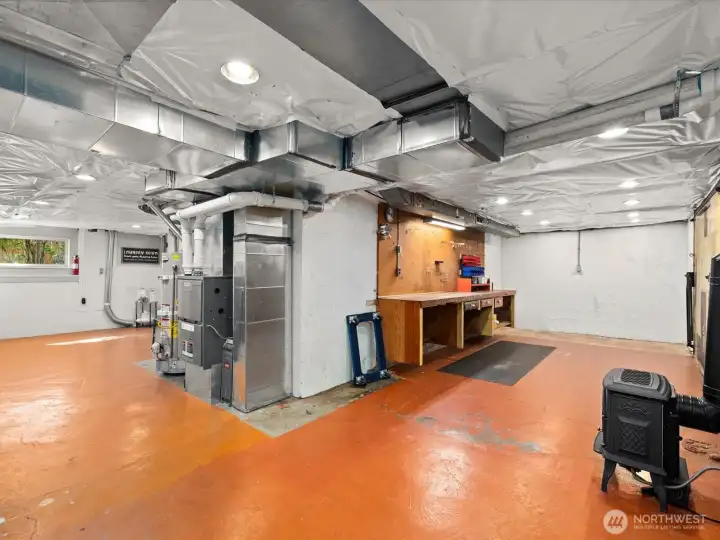Another view of lower level workshop with built in work bench
