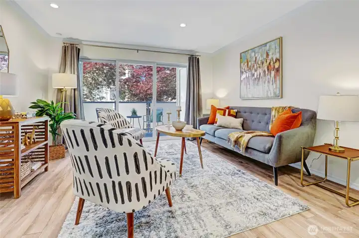 Living room with slider off to balcony with outdoor storage.