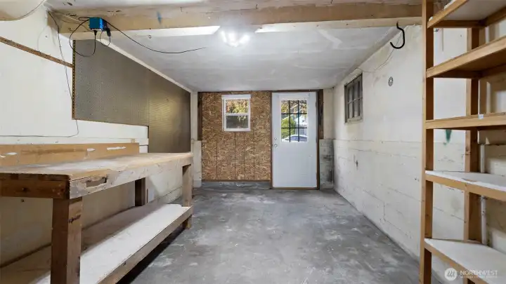 What a fantastic workshop! Complete with a sturdy built-in bench, plenty of shelving, and a pegboard ready for your tools and projects, this space is a dream setup for anyone who loves to tinker, build, or create.