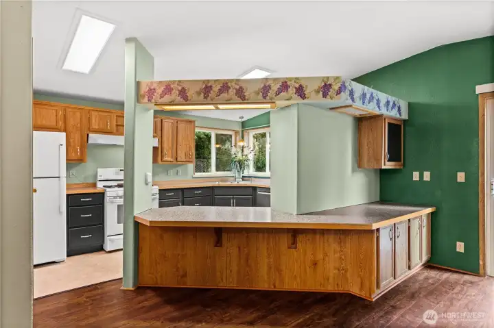 Cute kitchen with breakfast bar and table height counters.